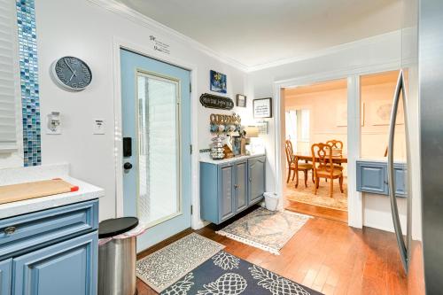 a kitchen with blue cabinets and a dining room at Magnolia House 1 Mi to Historic Georgetown in Georgetown