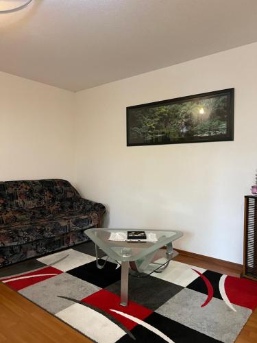 a living room with a couch and a table at L’Alsace autrement in Soultz-Haut-Rhin