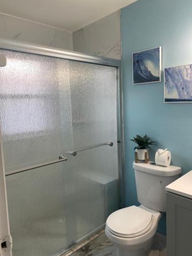 a bathroom with a toilet and a glass shower at Vera’s vacation in Bradenton