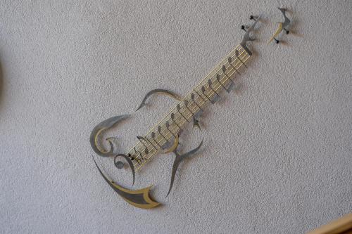 a guitar is hanging on a wall at Haus Walcher in Millstatt