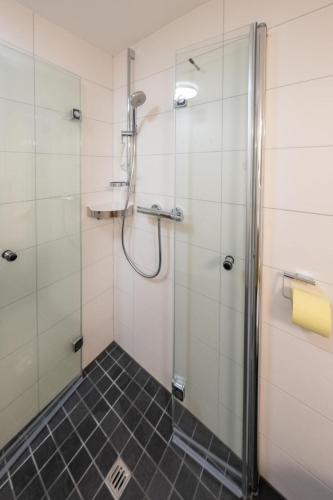 a bathroom with a shower with a glass door at Haus Walcher in Millstatt