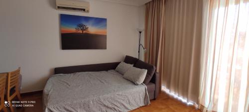 a bedroom with a bed and a picture of a tree at Apartment with pool and gardens near the coast in San Miguel de Abona