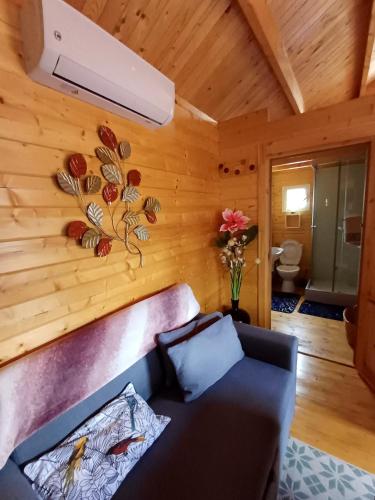 a living room with a couch and a fan at Chalet d'une chambre avec terrasse amenagee et wifi a L'Etang Sale in Étang-Salé