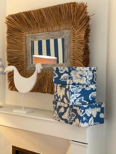 a shelf with a mirror and a stack of towels at Maison Marco in Espoey