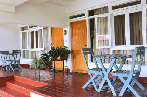 a porch with a table and chairs in front of a door at Hotel Mystic Buddha in Kathmandu