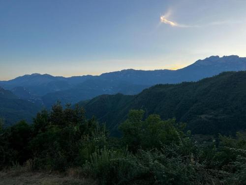 a view of a mountain range with the sun in the sky at Kolasin - Hunting home in old village in Kolašin