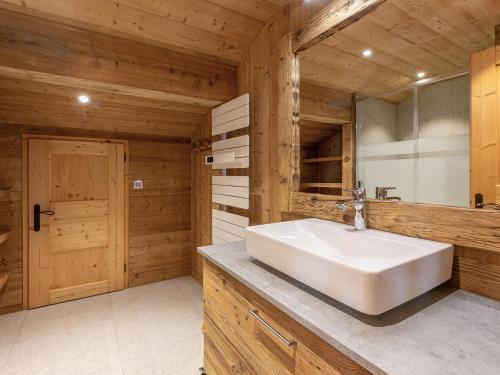 une salle de bain avec un lavabo blanc et un miroir dans l'établissement Chalet 4 Étoiles 13 Pers. à La Clusaz - Grande Terrasse, Garage, WIFI, Arrêt Skibus à Proximité - FR-1-437-81, à La Clusaz