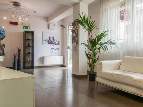 a living room with a couch and a plant at Residence Art in Rimini