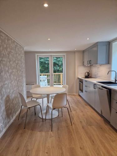 a kitchen with a table and chairs in a room at R apartment in Kungsängen in Kungsängen