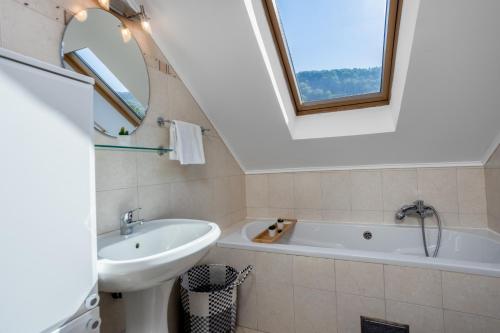 a bathroom with a sink and a bath tub at Holiday Home Došen in Vrbovsko