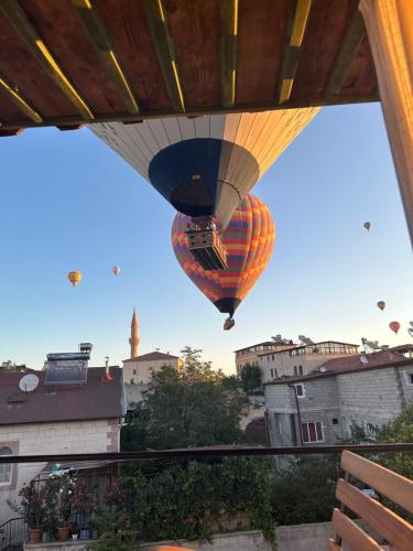 a hot air balloon is flying over a city at Aysel Inn House in Goreme