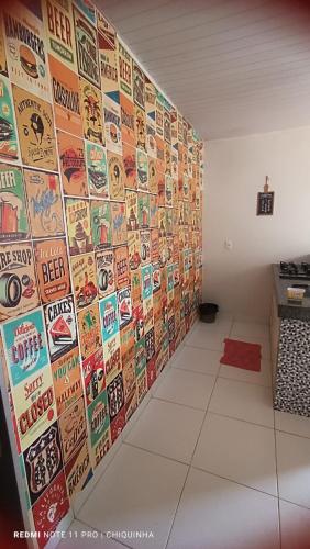 a room with a wall of stickers on the wall at Studio Aconchegante in Palmas