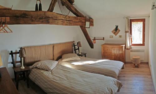 a bedroom with two beds and a wooden floor at A la Bonne Franquette in Droyes