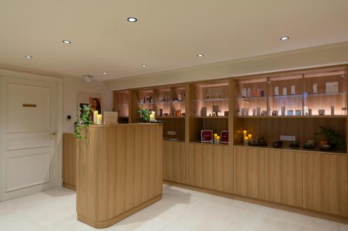 a room with wooden cabinets and a bar at Hôtel & SPA Napoléon in Fontainebleau