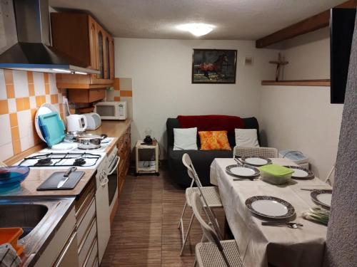a kitchen with a table and a kitchen with a couch at FILUTE in Vrbovsko