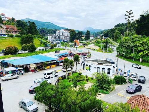 a city with cars parked in a parking lot at BRICKS Backpackers Sleepbox in Tanah Rata