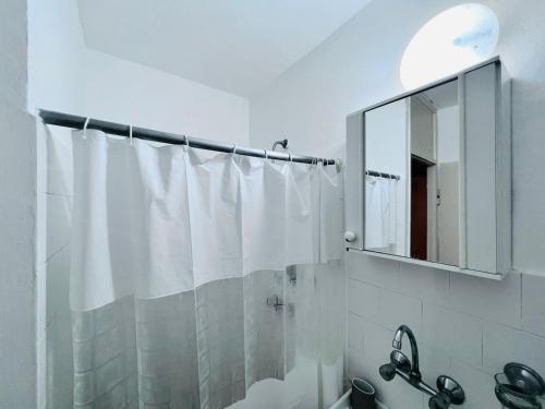 a bathroom with a shower curtain and a mirror at Good apartment 2 bedroom in Bat Yam