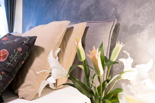 a group of pillows sitting next to a plant at STING Boutique Apartments in Ostrava