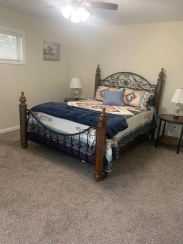 a bedroom with a bed with a wooden frame at Cute house in quiet neighborhood in Saginaw