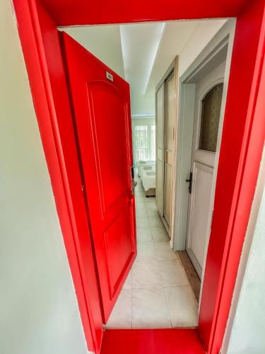 a red door in a room with a bathroom at Mercan Otel in Canakkale