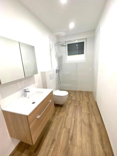 a bathroom with a sink and a toilet and a mirror at Neubauwohnung Lura 2b - für 5 Personen in Vienna