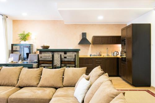 a living room with a couch and a kitchen at STING Boutique Apartments in Ostrava