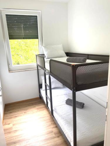 a room with two bunk beds and a window at Neubauwohnung Lura 2b - für 5 Personen in Vienna