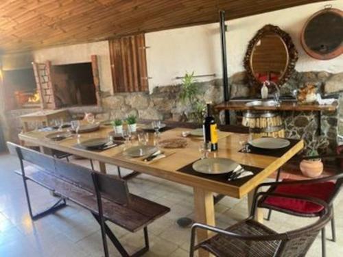 a dining room with a wooden table and chairs at Casa de Férias completa com Piscina privada, Casa do Vale - DOURO, independente, vistas deslumbrantes in Vilar de Maçada