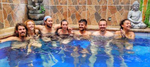 a group of men and women in a hot tub at Fatima Hostel Santa Marta in Santa Marta