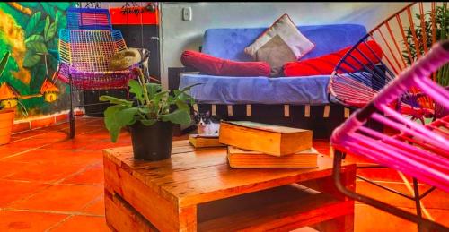 a living room with a blue couch and a table at Fatima Hostel Santa Marta in Santa Marta