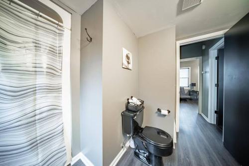 a bathroom with a toilet in a room at Walkable Gem in Little Italy in Cleveland