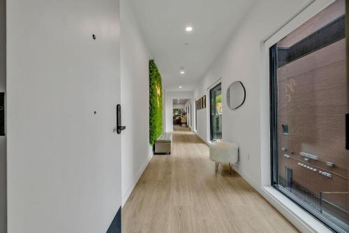 a hallway with white walls and a large window at HUGE downtown corner unit- Pool-Gym-Walk 2 Broadway in Nashville