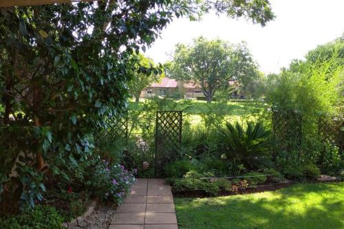 a garden with a gate in a yard at Pecanwood Treasure Hartbeespoort Dam in Hartbeespoort