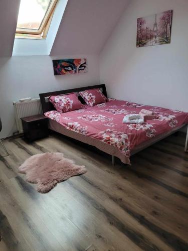 a bedroom with a bed and a rug on the floor at Casa Eni in Cluj-Napoca
