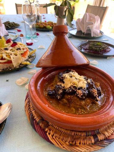 a red plate of food on a table at Riad des Fragrances dar el Bacha in Marrakech