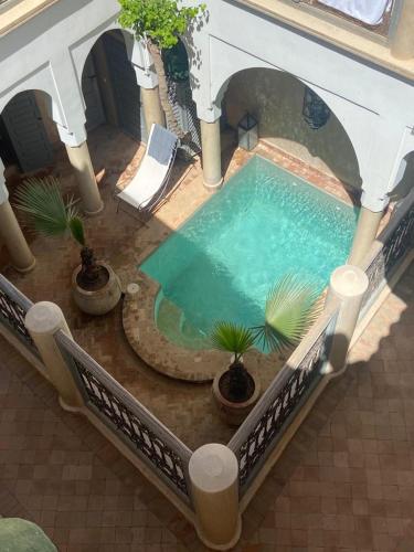 an overhead view of a swimming pool in a building at Riad des Fragrances dar el Bacha in Marrakech