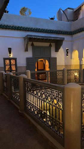 a house with a fence in front of it at Riad des Fragrances dar el Bacha in Marrakech