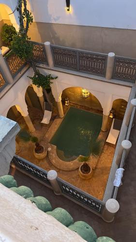 an overhead view of a swimming pool in a building at Riad des Fragrances dar el Bacha in Marrakech