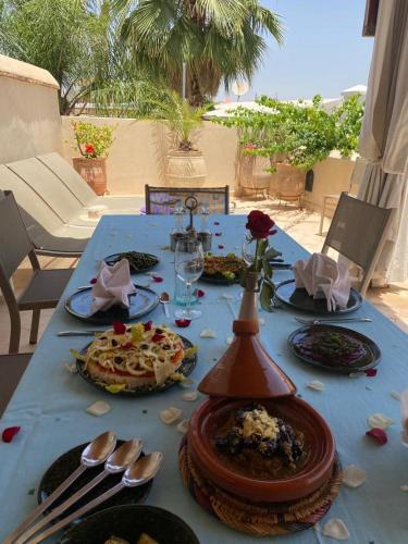 a blue table with plates of food on it at Riad des Fragrances dar el Bacha in Marrakech