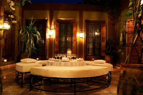 a large room with a table with wine glasses at Dar Ayniwen Garden Hotel & Bird Zoo in Marrakesh