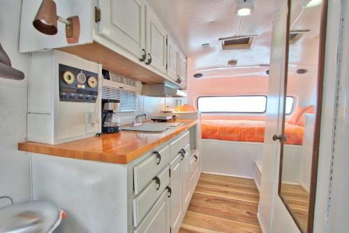 A cozinha ou cozinha compacta de The Driftwoods - Retro Red RV
