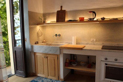 eine Küche mit einer Spüle und einer Arbeitsplatte in der Unterkunft Namaste apartment Fiumelatte in Varenna