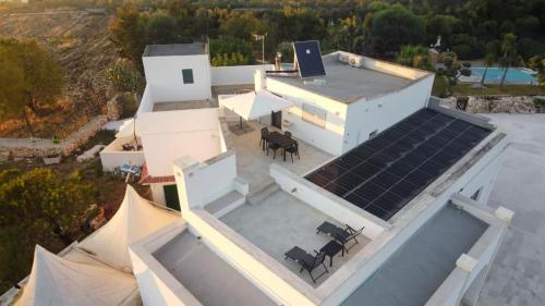 an aerial view of a house with solar panels on the roof at Dimora Caraspi in Mola di Bari