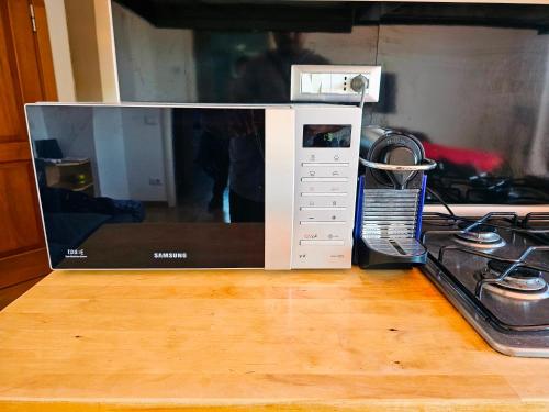 a microwave oven sitting on top of a wooden floor at Panoramic Sunset Terrace Attic in Rome