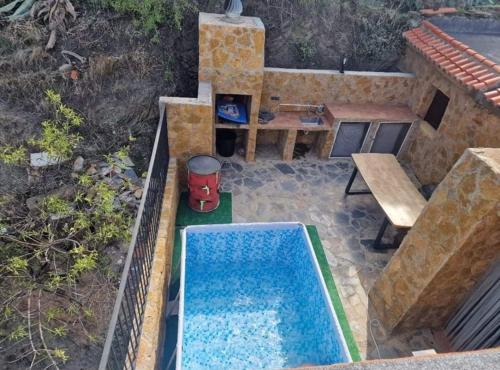 an overhead view of a backyard with a swimming pool and a table at Casa Rural Serrano in Abrucena