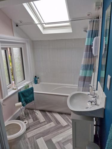 a bathroom with a tub and a toilet and a sink at Fylde Court in Morecambe