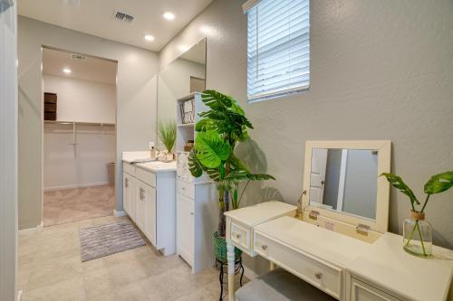 a bathroom with a sink and a mirror at Buckeye Verrado Area Home with Pergola and Fire Pit in Litchfield Park