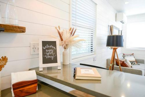a desk with a chalkboard in a room at New Luxury Shipping Container in Bellmead