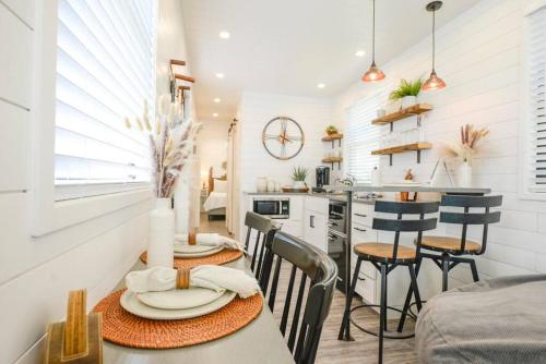 a kitchen and dining room with a table and chairs at New Luxury Shipping Container in Bellmead