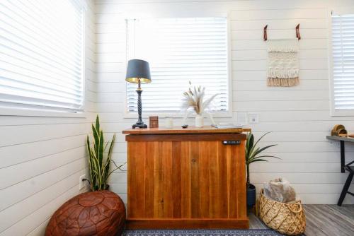 a room with a table with a lamp on it at New Luxury Shipping Container in Bellmead